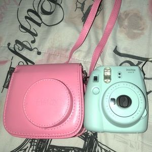 -Baby blue polaroid camera with pink travel case